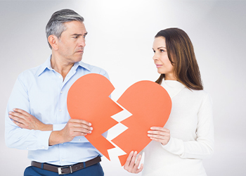 Mature couple holding a broken heart